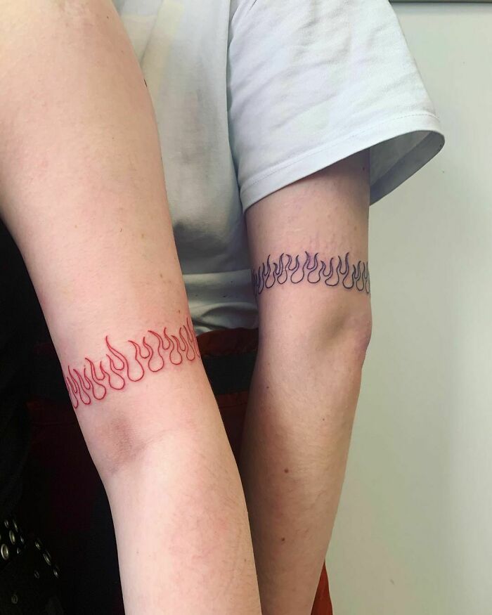 Red and dark blue flame matching tattoos