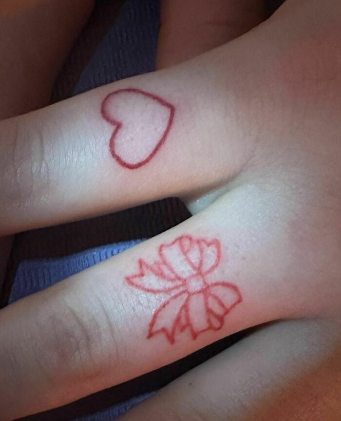 Bow and heart finger tattoos 