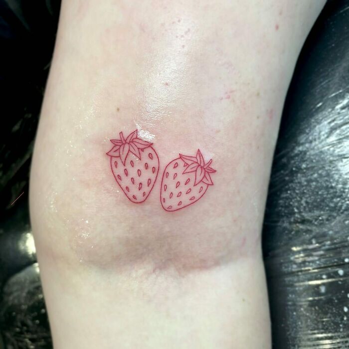 Two red strawberries tattoo