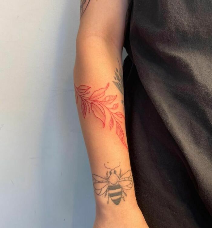 Bee and red leaves arm tattoos 