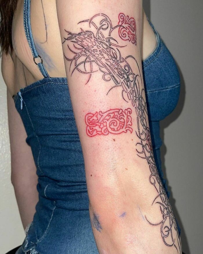 Red arm piece tattoo 