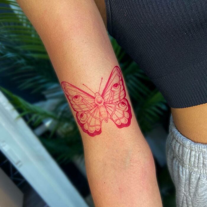 Red butterfly with eyes tattoo