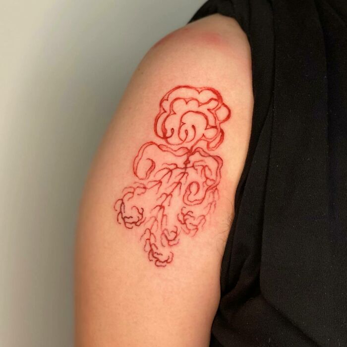 Red ink arm tattoo 