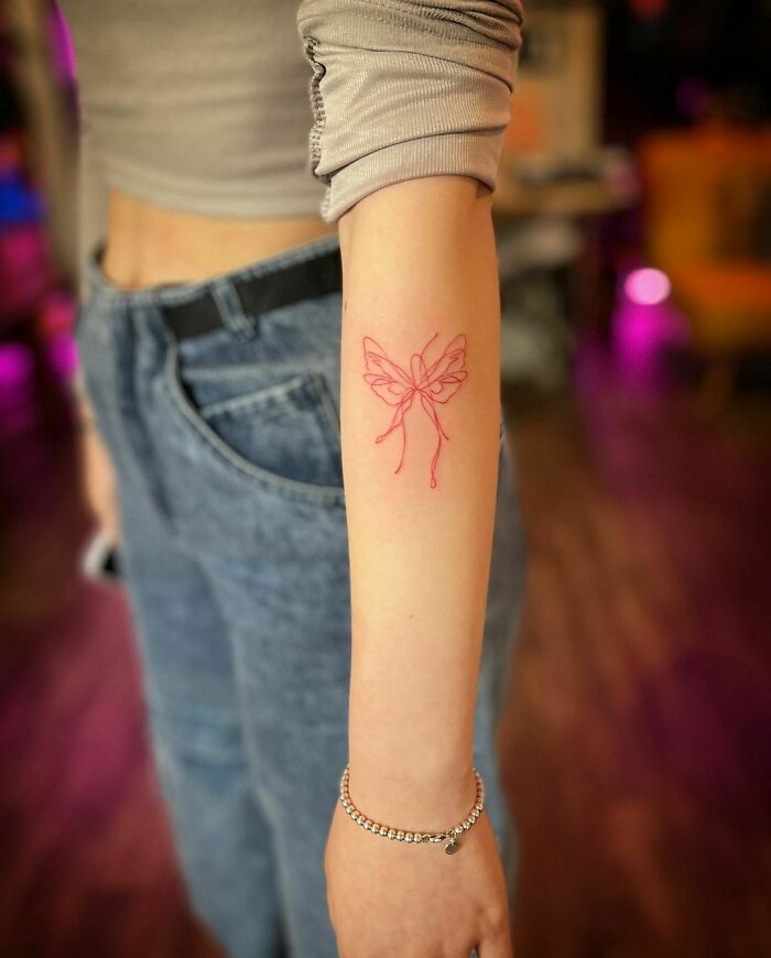 Butterfly red arm tattoo 