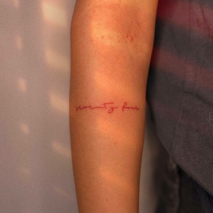 Red inscription tattoo 