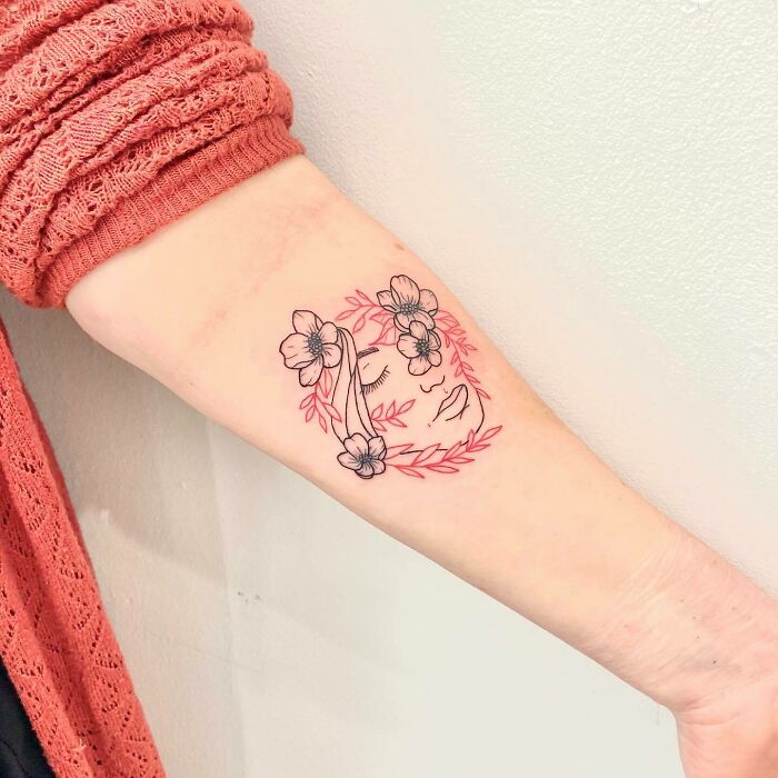 Lined face and flowers tattoo 