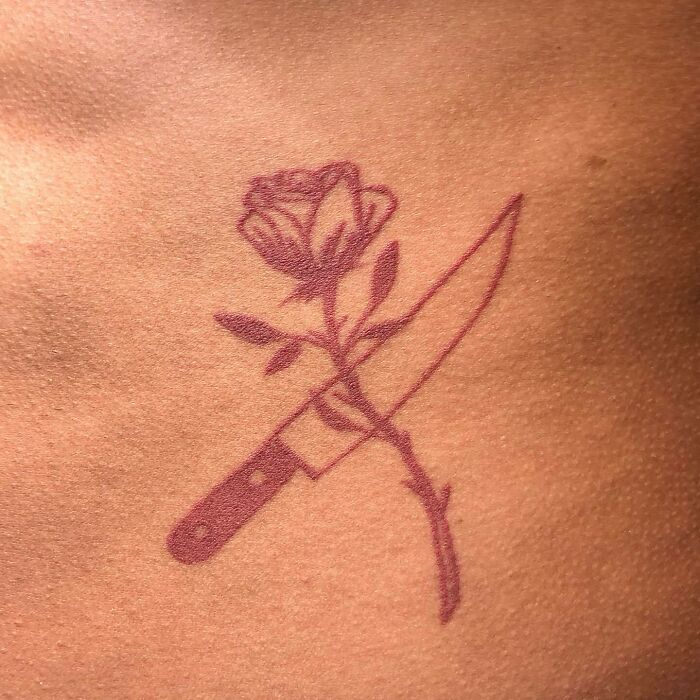 Red rose and knife tattoo 