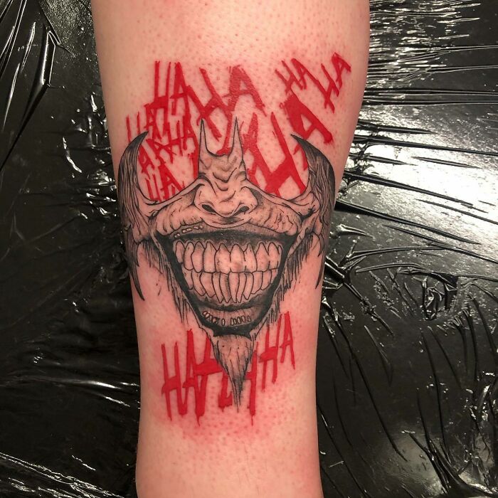 Jokers' smile and Batmen symbol tattoo