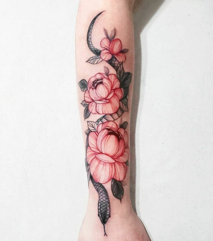 Snake and red flowers arm tattoo 