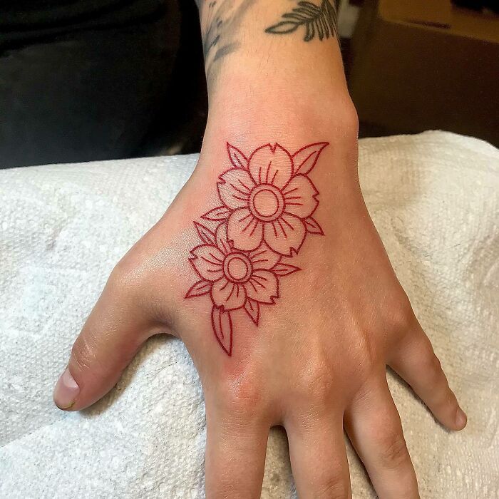 Red flowers hand tattoo
