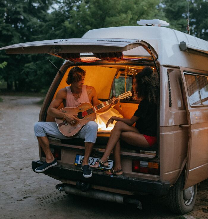 Man Singing With A Guitar To A Girl 