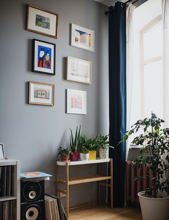 Creative decoration ideas with framed art and potted plants in a cozy living room corner.