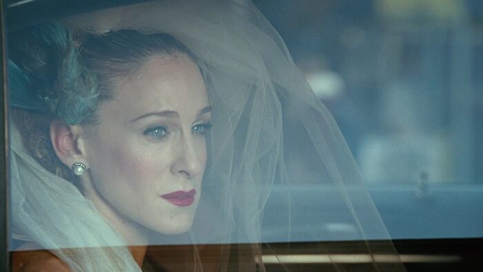 Carrie in the car wearing wedding veil 