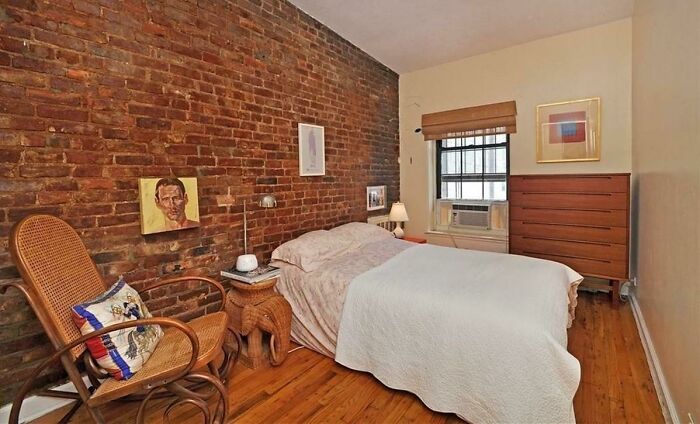 Photo of bedroom with brick wall