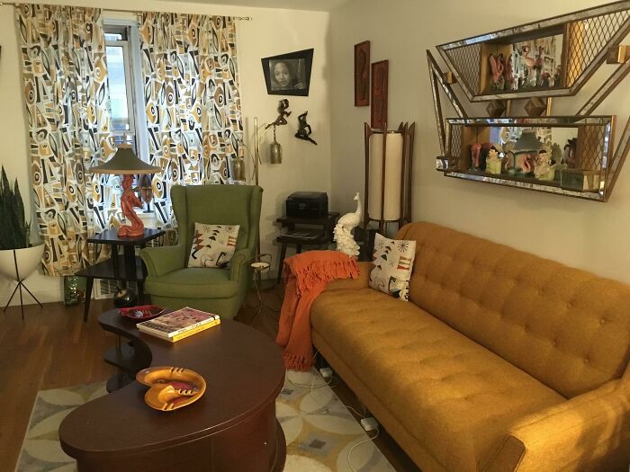 Creative decoration idea in a cozy living room featuring retro furniture, colorful curtains, and eclectic wall art.