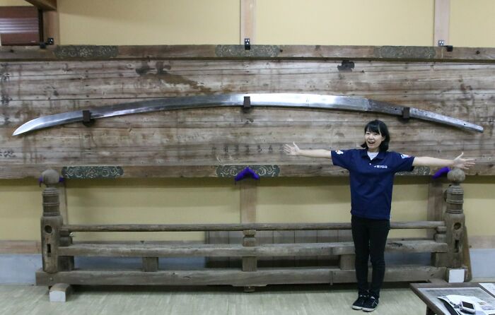 The Hanja-No-Ontachi Sword, In The Hananoka Hachimangu Shrine In Japan. Stands At An Amazing 15.25 Feet. Human For Scale