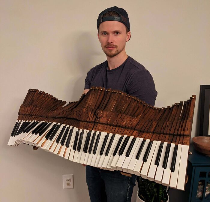 Man holding reclaimed piano keys