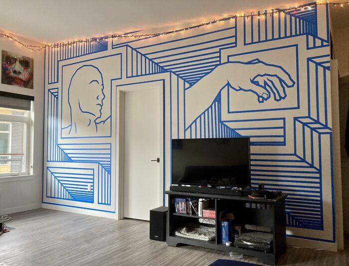 Creative decoration idea featuring abstract wall art with blue geometric patterns and outlined figures.