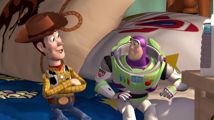 Woody and Buzz Lightyear sitting on a bed, showcasing iconic best friend duos in animation.