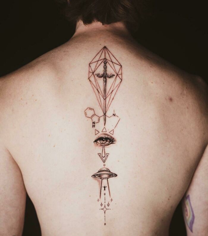 Sword, geometrical shape, chemical formula, eye, space ship abducting human tattoo 
