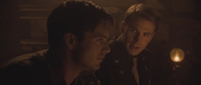 Two soldiers sitting together in dim light, representing iconic best friend duos in a heartfelt moment.