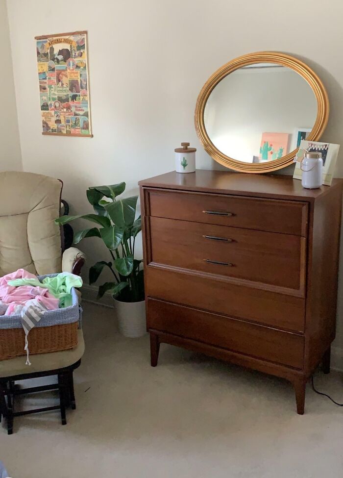 Photo of nightstand table with vintage mirror on it