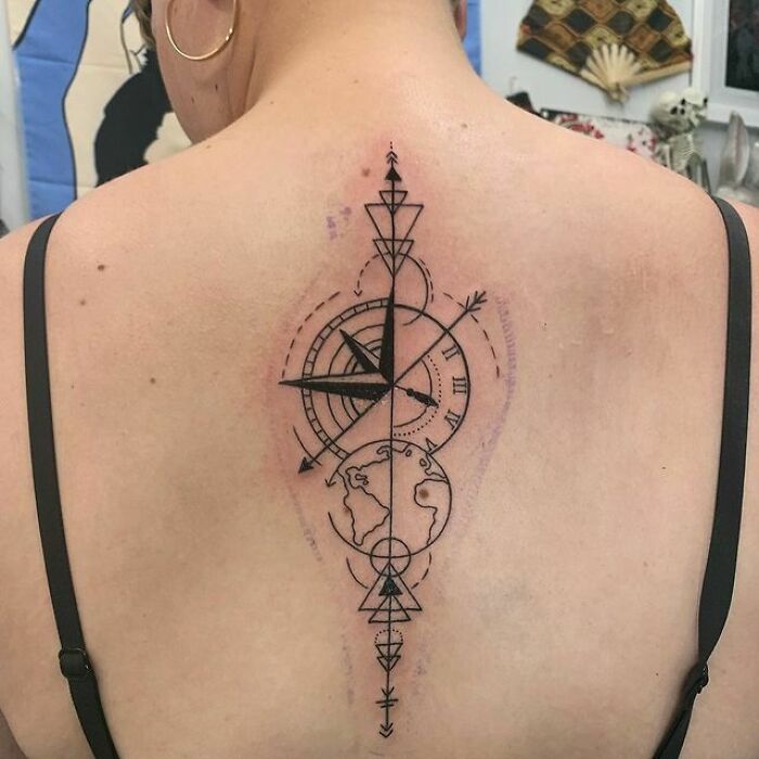 Abstract linear geometric compass and Earth tattoo on back