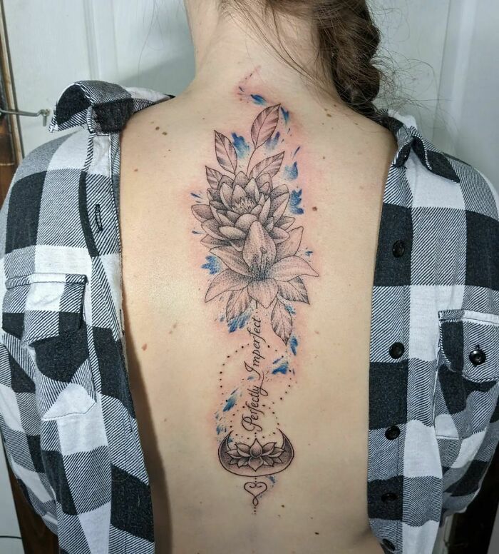 Lettering and flowers tattoo on back