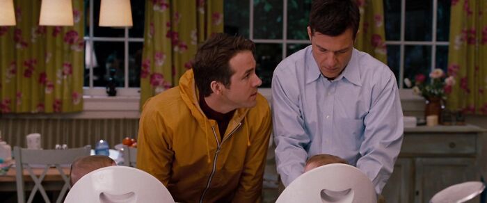 Two men in a kitchen, one in a yellow jacket, one in a blue shirt, engaging with children, showcasing iconic best friend duos.