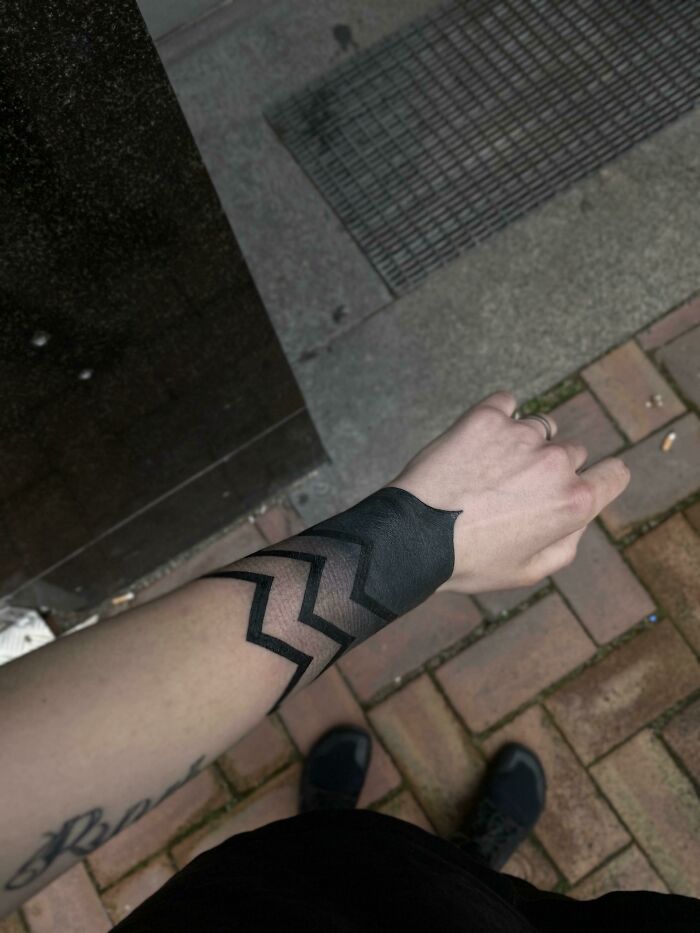 Gradient lines tattoo around wrist