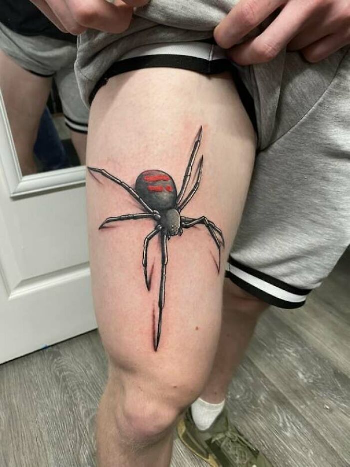 Realistic spider tattoo on thigh showcasing intricate animal tattoo design.
