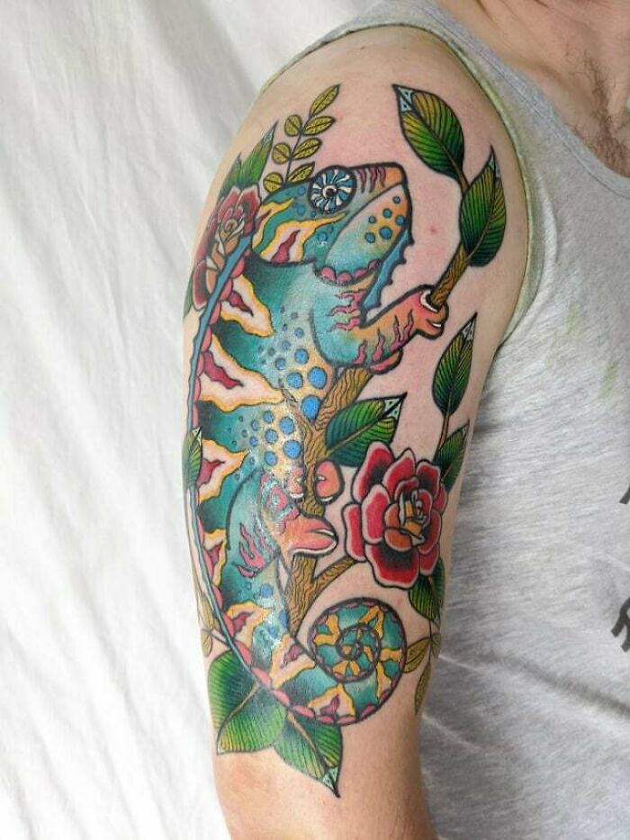Colorful animal tattoo of a lizard and flowers on an arm, showcasing vibrant and creative inspiration.