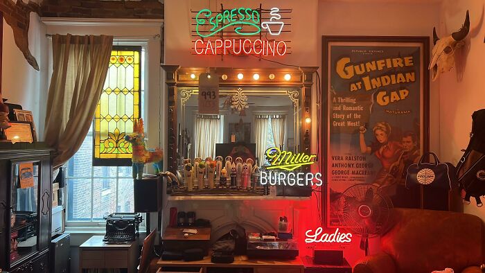 Creative decoration with vintage signs, neon lights, and retro posters in a cozy room setting.