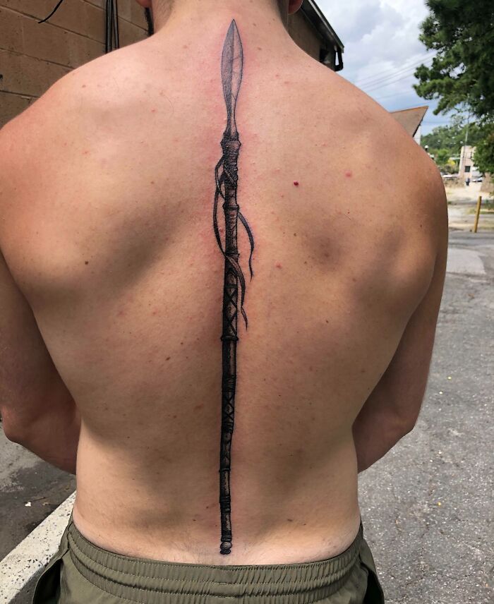 Spear along the spine tattoo 