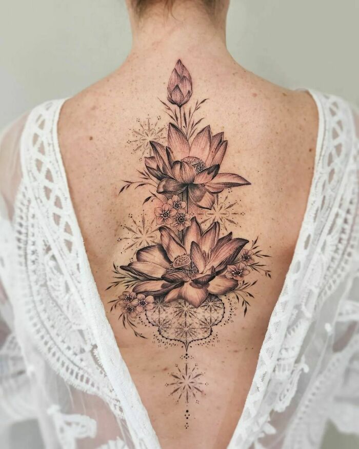 Realistic lotus flowers back tattoo