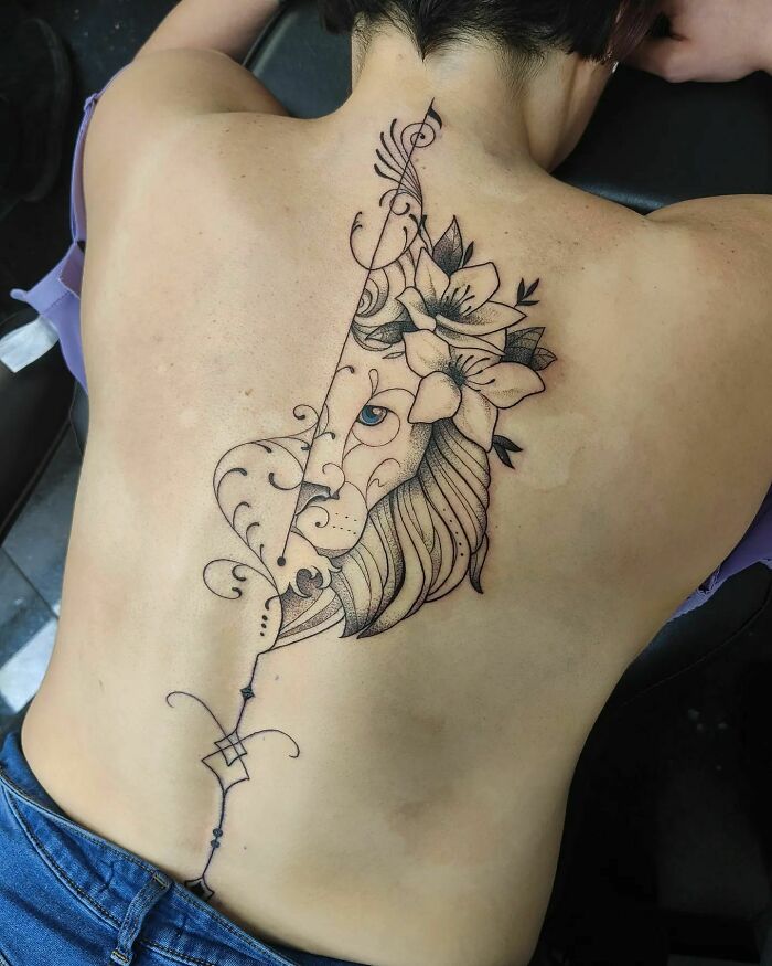 Half lions' head and flowers on the back tattoo 