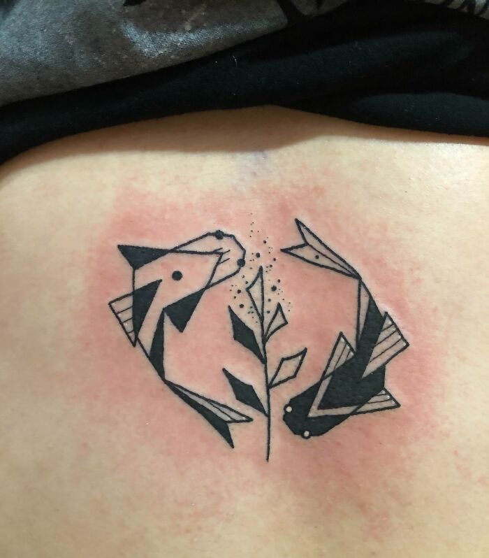 Two black fish tattoo
