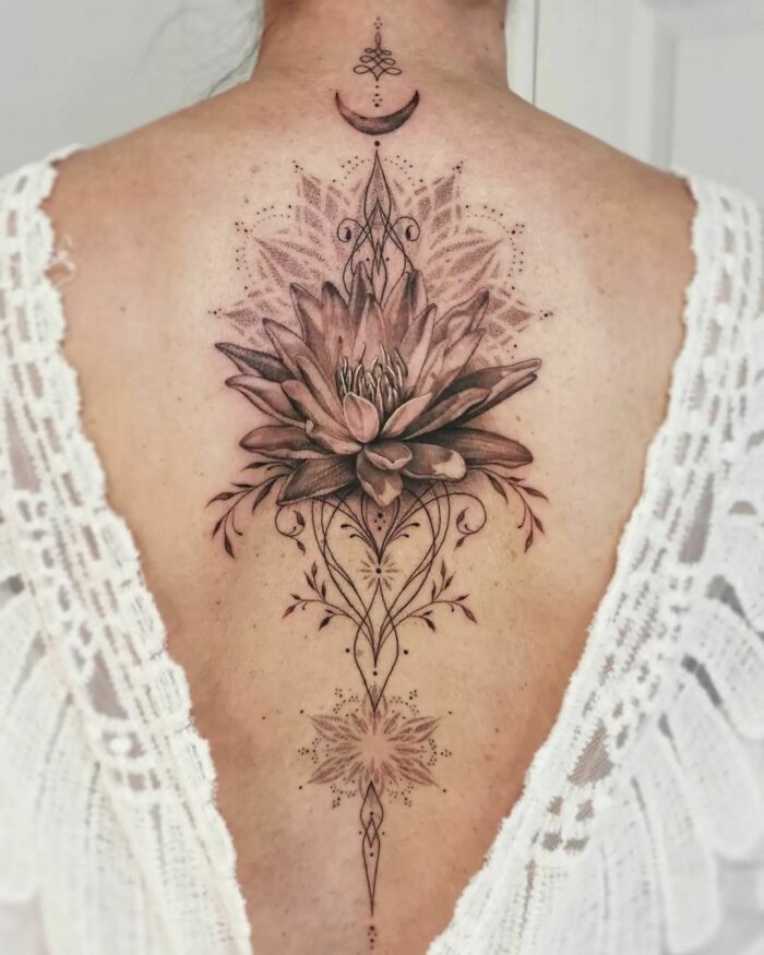 Flower and mandala along the spine tattoo