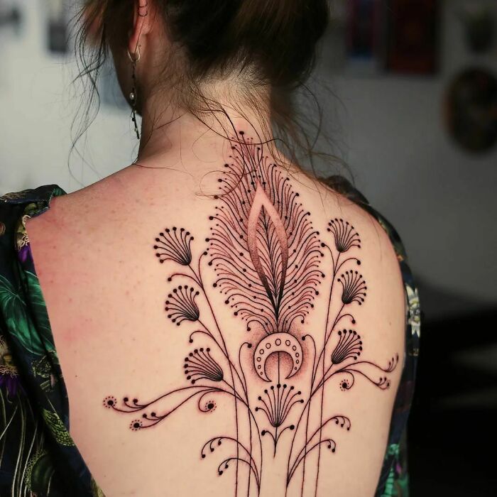 Black ornamental spine tattoo 