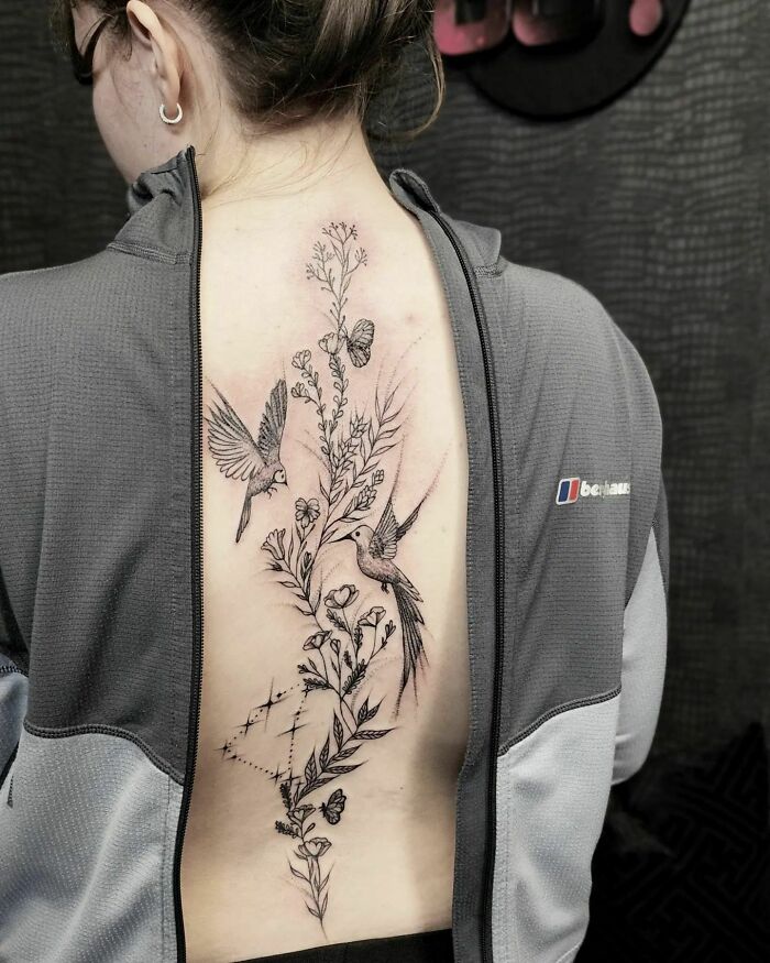 Two humming birds and flowers back tattoo