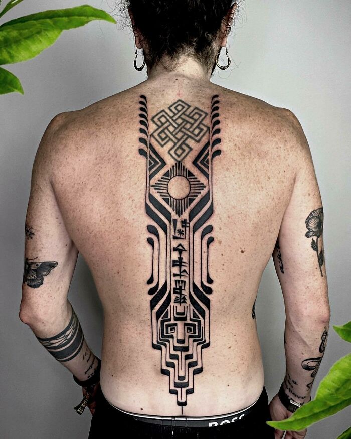 Symbols along the spine and back tattoo 