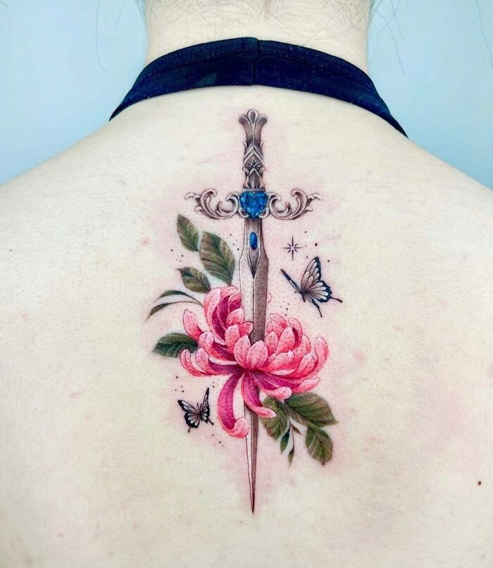 Realistic colorful sword, peony and, butterflies tattoo on upper back