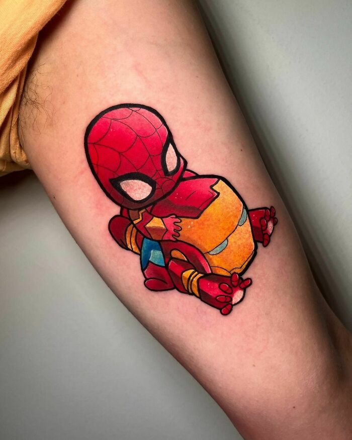 Baby Spiderman superhero tattoo in vibrant colors on a person's skin.