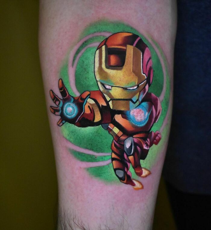 Marvel tattoo of Iron Man in action, with vibrant colors and dynamic pose on a person's arm.