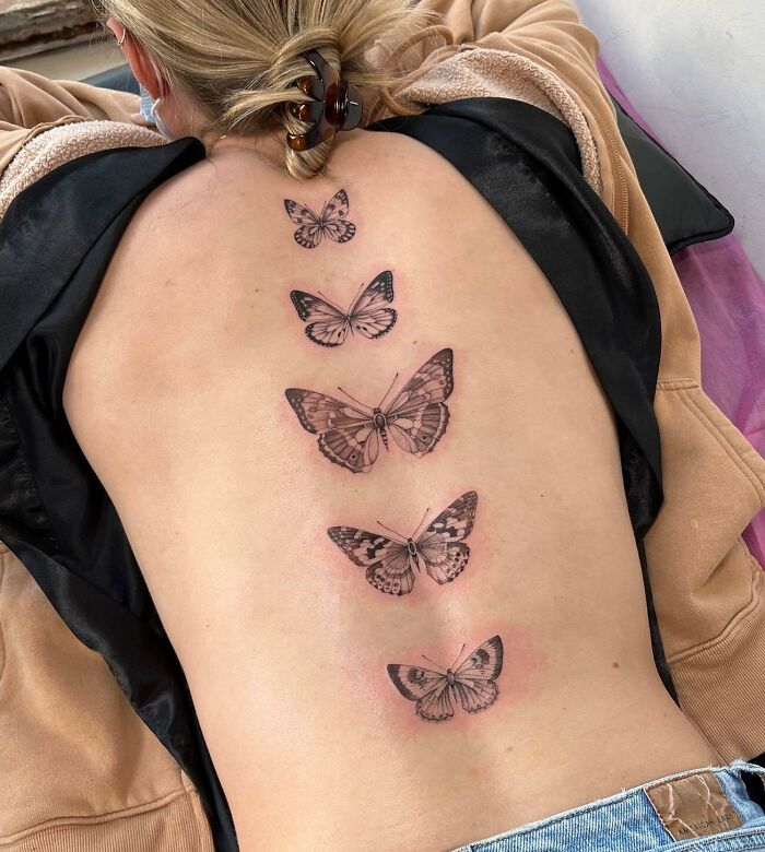 Butterflies along the spine tattoo 
