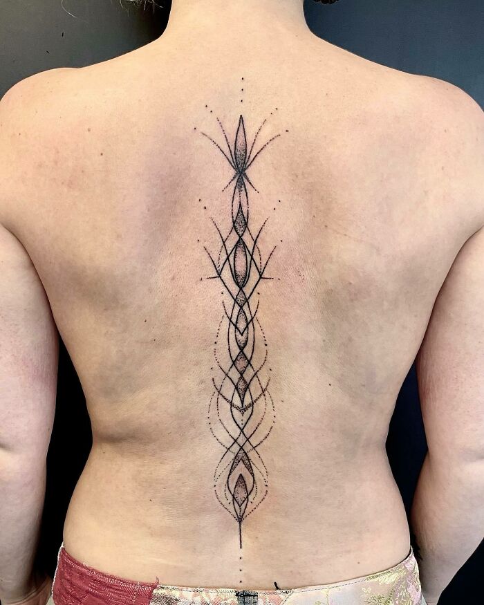 Abstract figures spine tattoo 