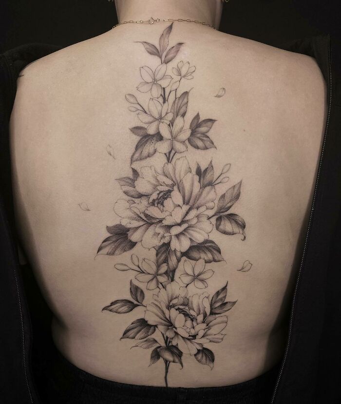 Flowers along the spine tattoo 