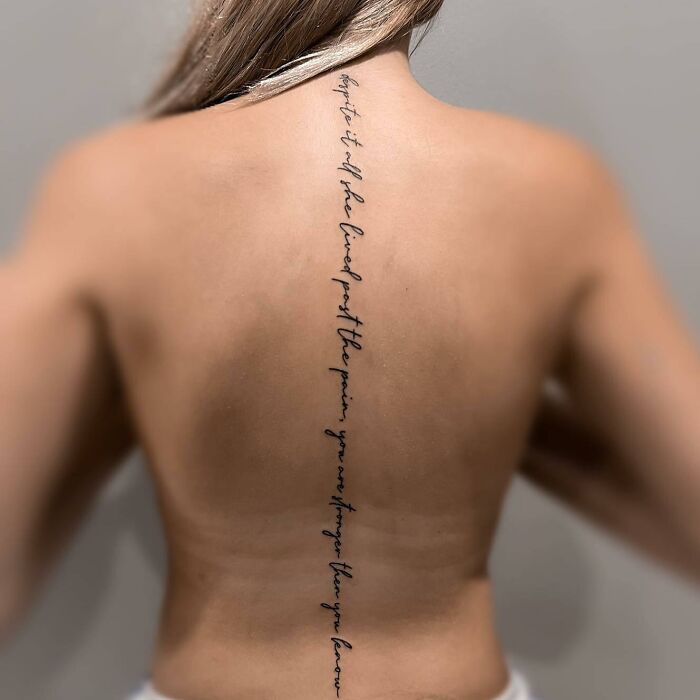Spine Tattoo With Text Line
