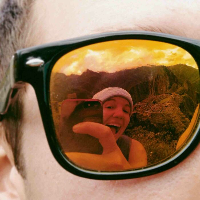 Woman taking a picture from other man's glasses 