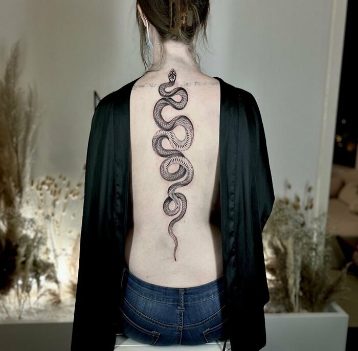 Snake along the spine tattoo 